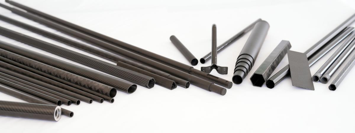 Custom carbon fiber tubes in round, hexagonal, square, and octagonal profiles across multiple diameters, manufactured by Xinbo Composites